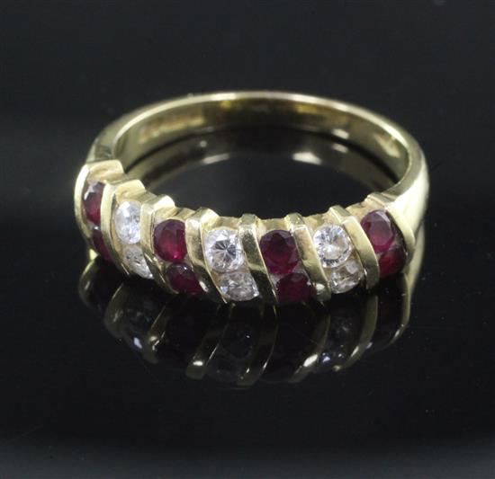 An 18ct ruby and diamond half hoop dress ring, size O.